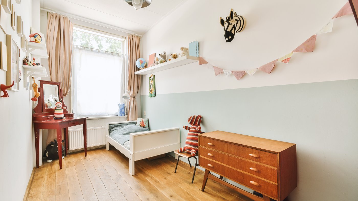 A quiet, empty child's bedroom in soft daylight
