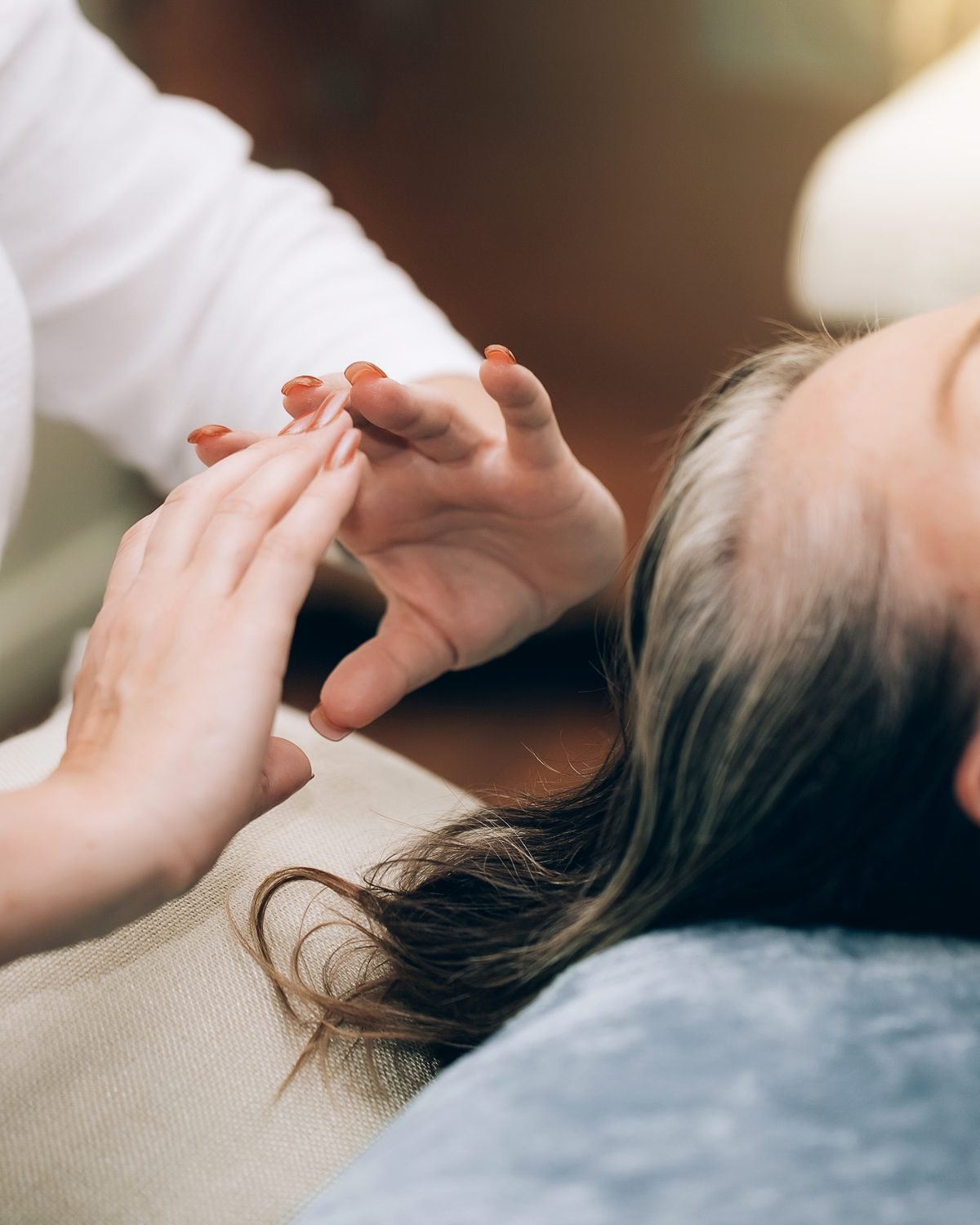 Hands giving a calm energy healing session