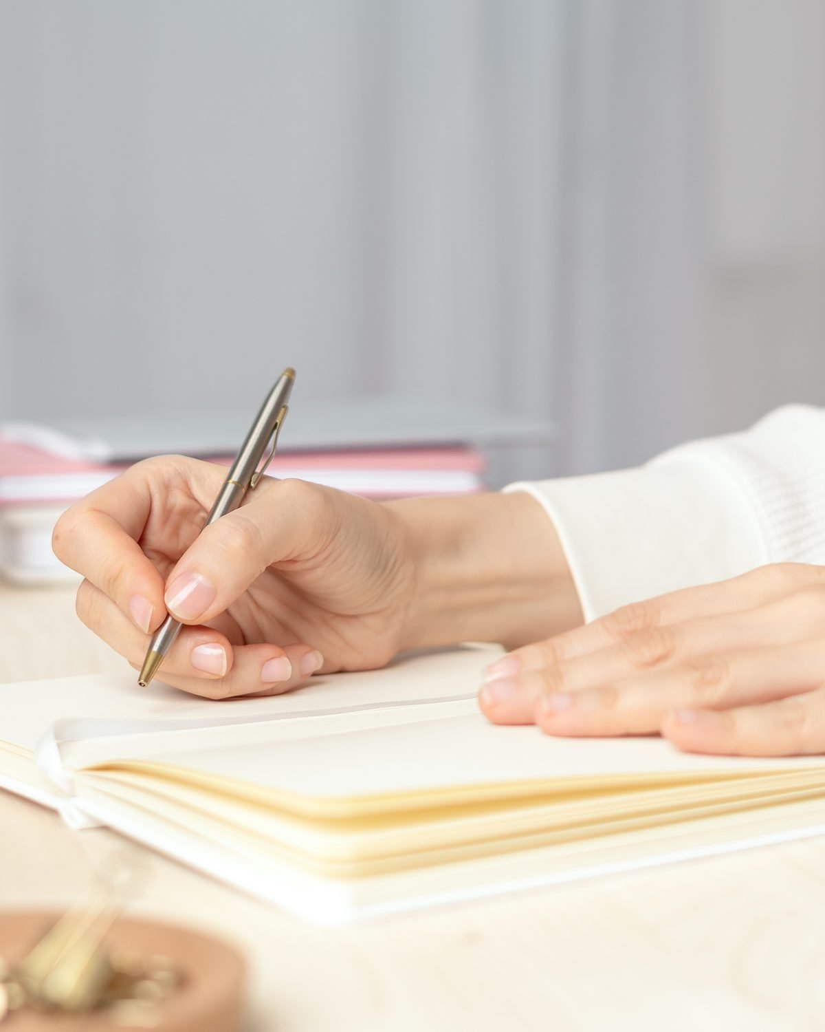 Writing in a journal at a calm desk with flowers